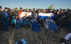 NASA Flight Engineer Karen Nyberg, left, Expedition 37 Commander Fyodor Yurchikhin of Roscosmos, center, and European Space Agency Flight Engineer Luca Parmitano sit in chairs outside the Sojuz capsule just minutes after they landed in Kazakhstan. Image Credit: NASA/Carla Cioffi