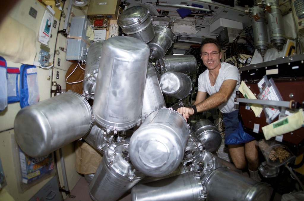 Astronaut Carl E. Walz, Expedition Four flight engineer, catalogs canisters of water in the Zvezda Service Module on the International Space Station (ISS). Credit: NASA