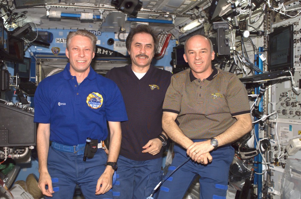 European Space Agency (ESA) astronaut Thomas Reiter (left), Expedition 13 flight engineer; cosmonaut Pavel V. Vinogradov, commander representing Russias Federal Space Agency; and astronaut, Army Col. Jeffrey N. Williams, NASA space station science officer and flight engineer, join Chef Emeril Lagasse for a special call in the Destiny laboratory of the International Space Station. Earlier the crew tasted several of his gourmet creations, delivered to the station by the Space Shuttle Discovery in July.