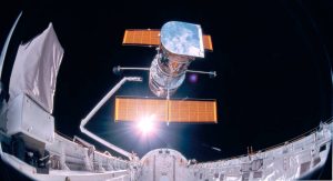 STS-31 ONBOARD SCENE --- This photograph was taken by the STS-31 crew aboard the Space Shuttle Discovery and shows the Hubble Space Telescope being deployed on 04/25/90 from the payload bay. The giant telescope is being put in orbit to gather information about a large variety of astronomical objects, from neighboring planets and stars to the most distant galaxies and quasars. The photo was taken by the IMAX Cargo Bay Camera mounted in a container on the port side of Discovery in Bay 12. The camera was remotely controlled by the crew members in the cabin using a Gas Autonomous Payload Controller.